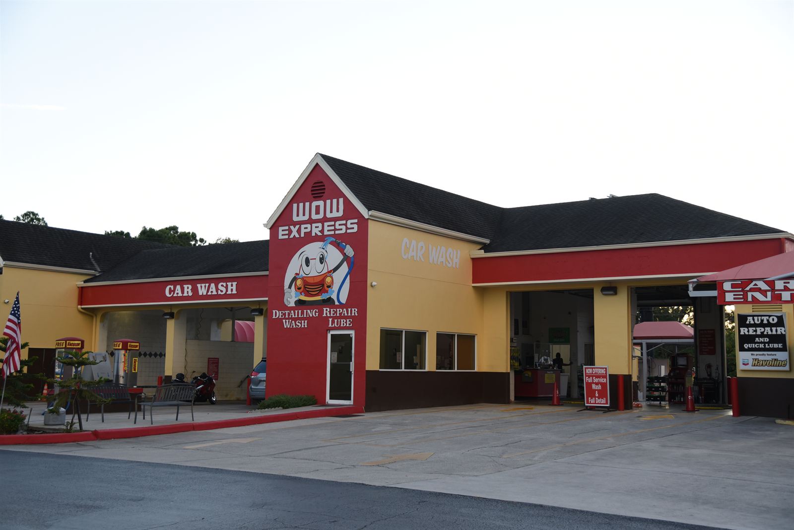 The Wow Express mascot mural — Detailing, Wash, Repair, Lube — on the car wash building