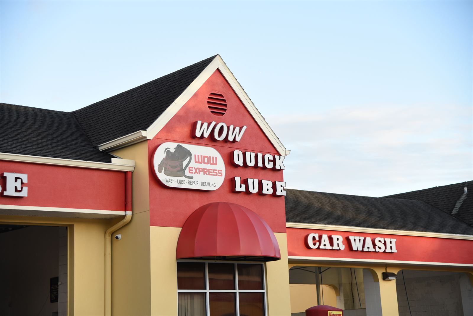 Wow Quick Lube sign on the red gable of the building